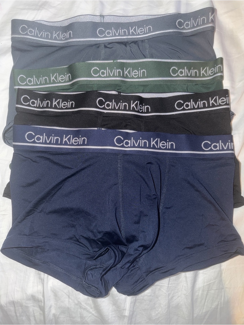 Calvin Klein 4-Pack athletic shorts in Gray, Green, Black, and Navy